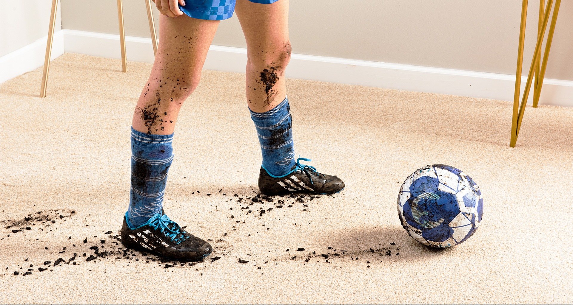 messy carpet from muddy soccer cleats and soccer ball