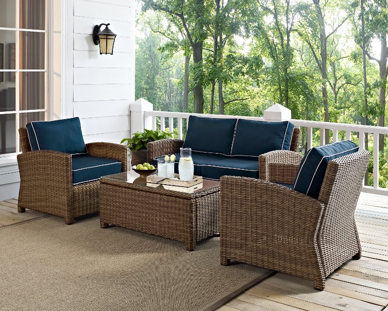navy and brown wicker patio furniture loveseat, arm chairs, and