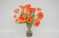 Orange Ranunculus Arrangement In Clear Vase