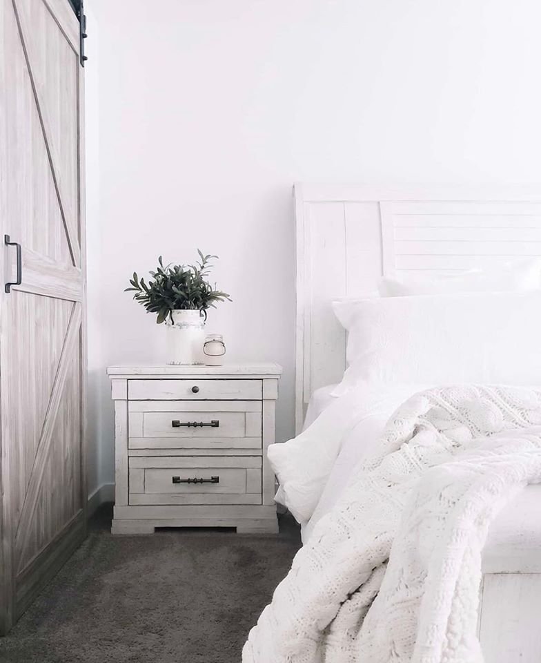 White farmhouse bed and nightstand