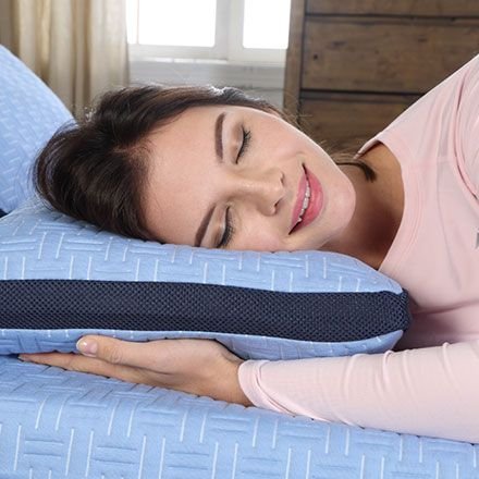 Woman resting her head on a Blue Burrito pillow and mattress
