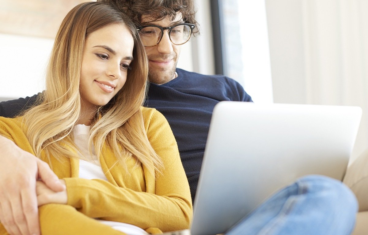 young couple looking at a laptop