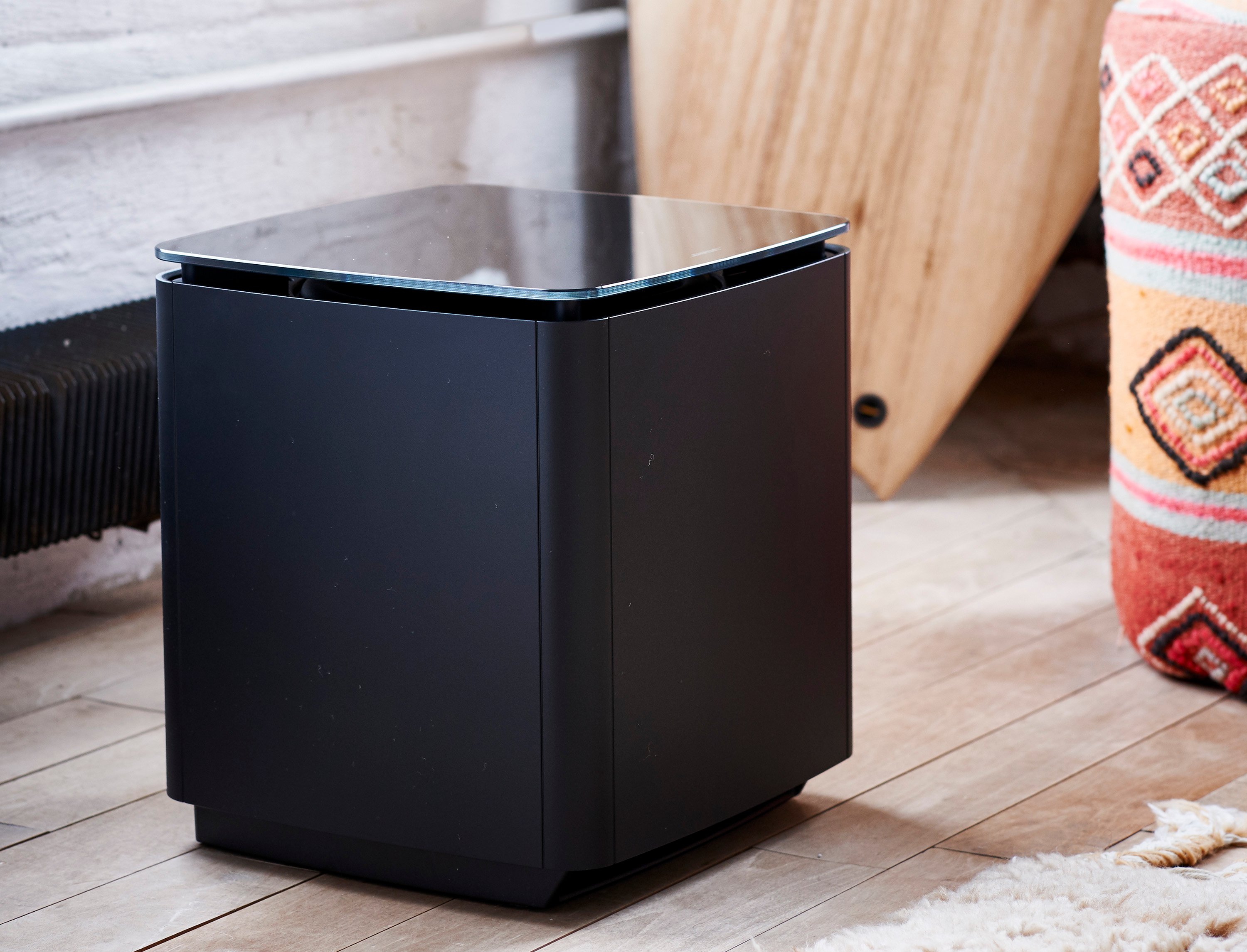 Lifestyle shot of black Bose Acoustimass bass speaker