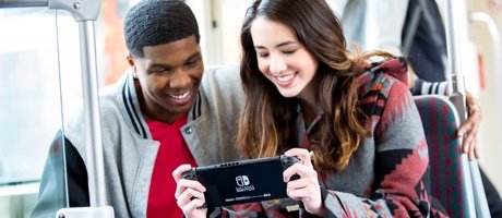 people playing Nintendo Switch in handheld mode