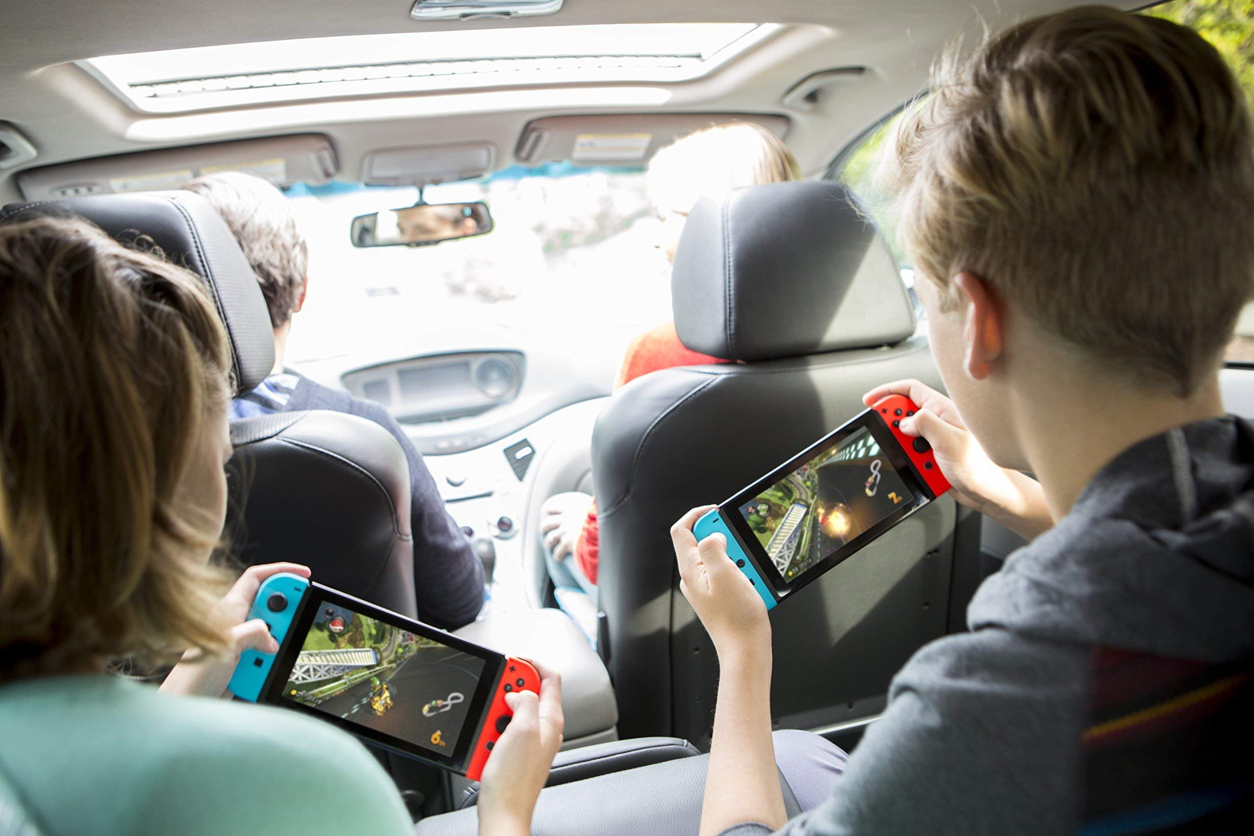 playing Nintendo Switch in handheld mode in a car