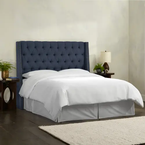 Hillcott ivory upholstered king bed with tufted back and store wingback detail