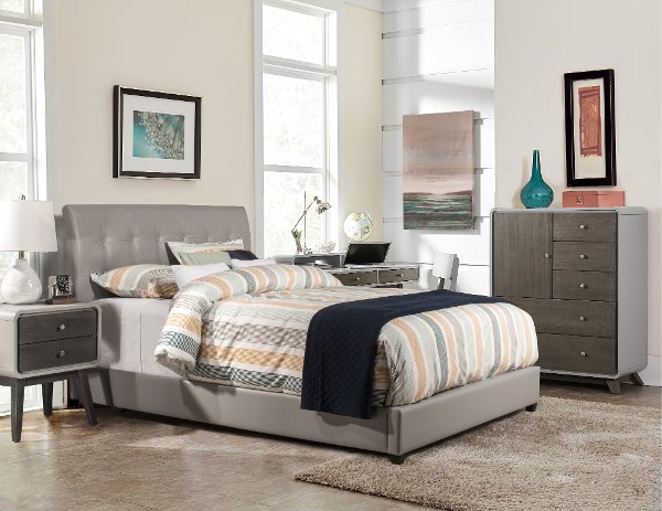 Gray upholstered bed inside a bedroom
